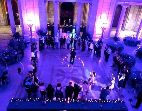 bride and groom dance with purple lights