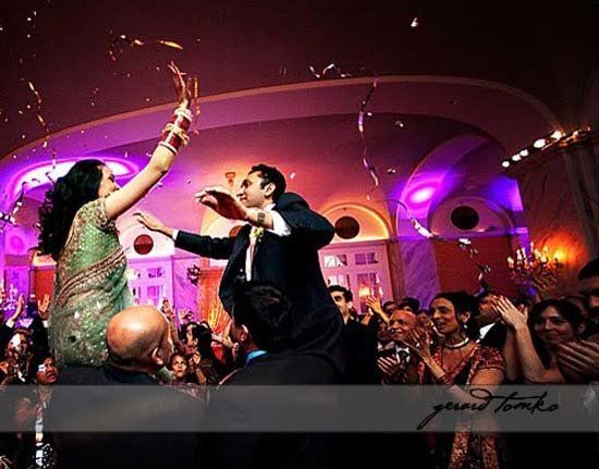 wedding party lifting up bride and groom
