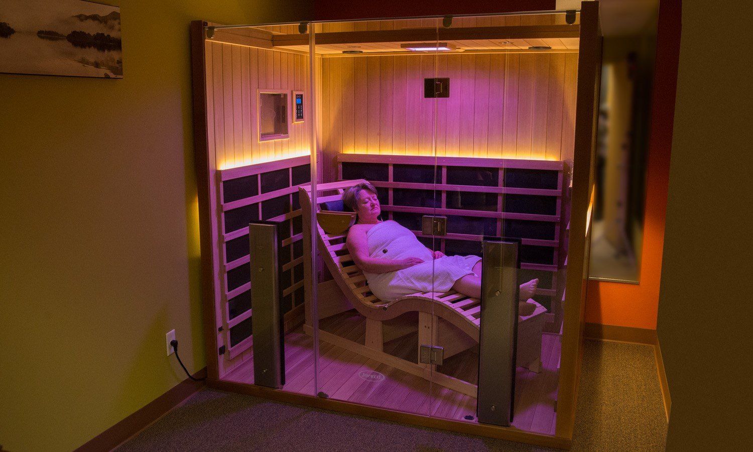 A man and a woman are sitting in a sauna.