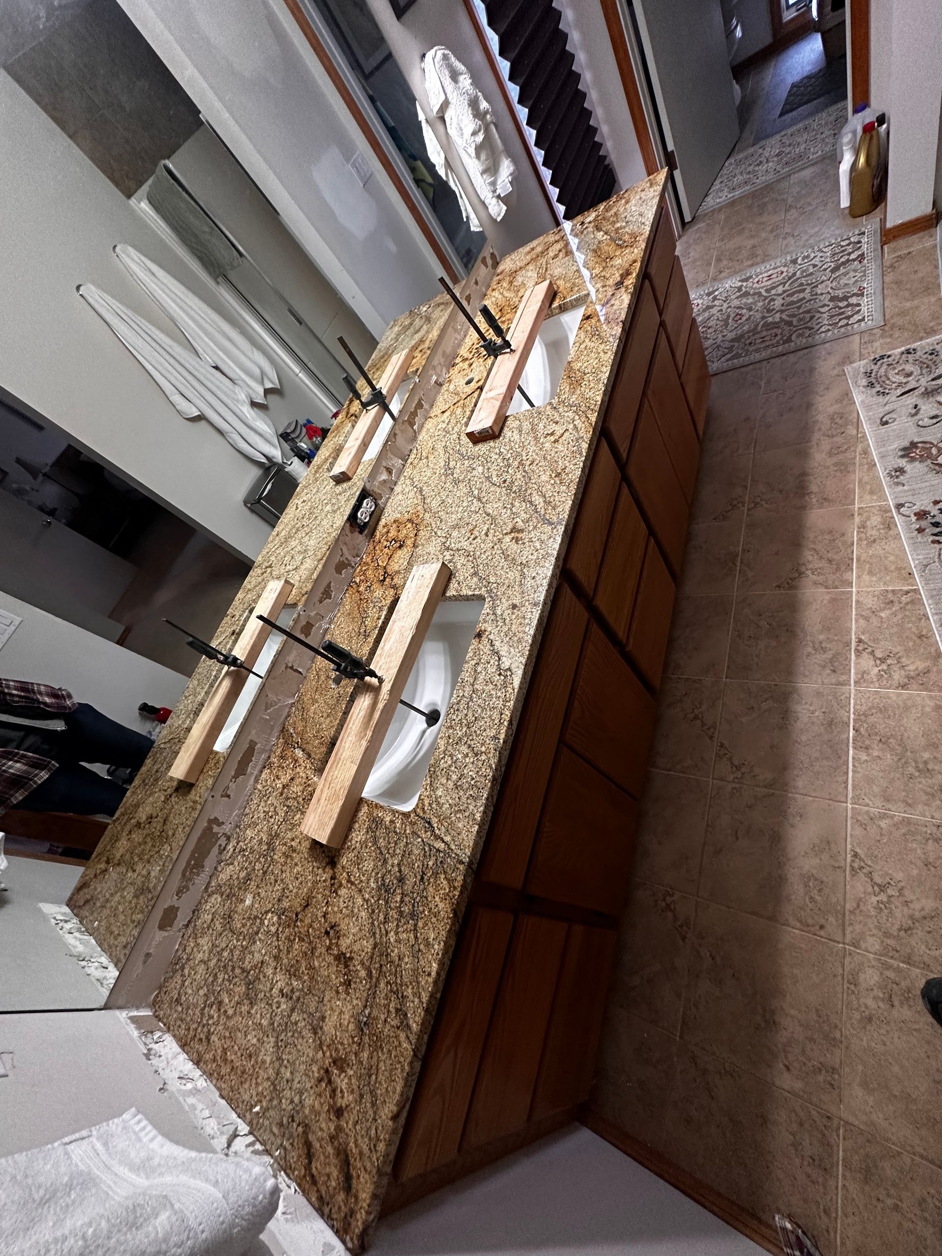 Stainless steel kitchen sink installation; plumbing equipment on countertop.