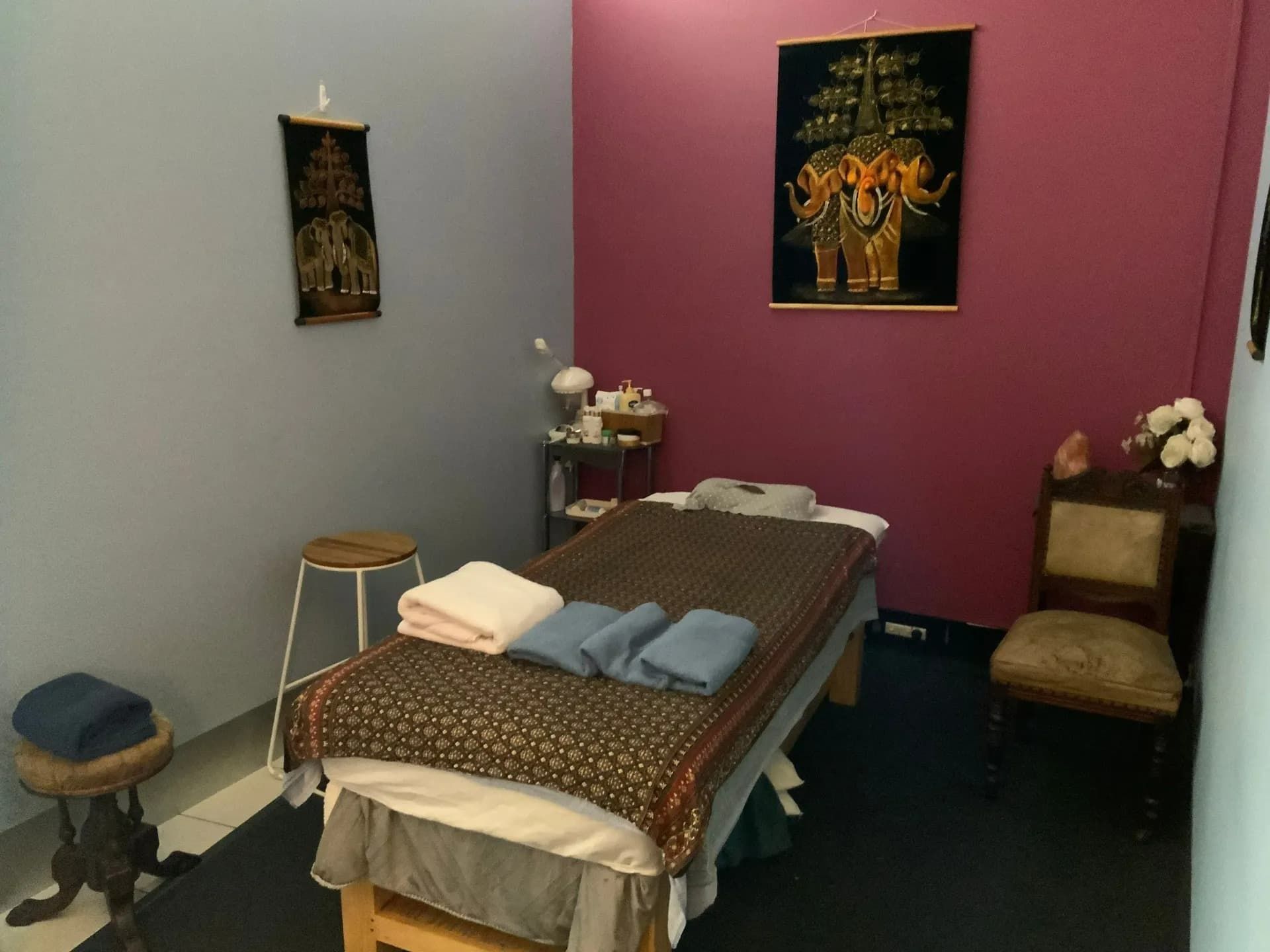 A Massage Table in a Room With a Picture of Elephants on the Wall — Nancy's Traditional Thai Massage In Buderim, QLD