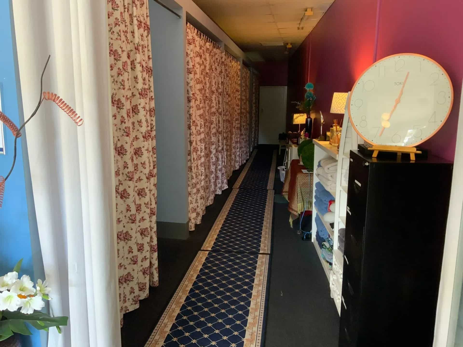 A Long Hallway With a Carpet and Curtains in a Room — Nancy's Traditional Thai Massage In Buderim, QLD