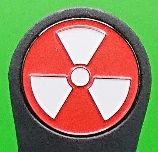 Radiation hazard symbol in red and white on a black background.