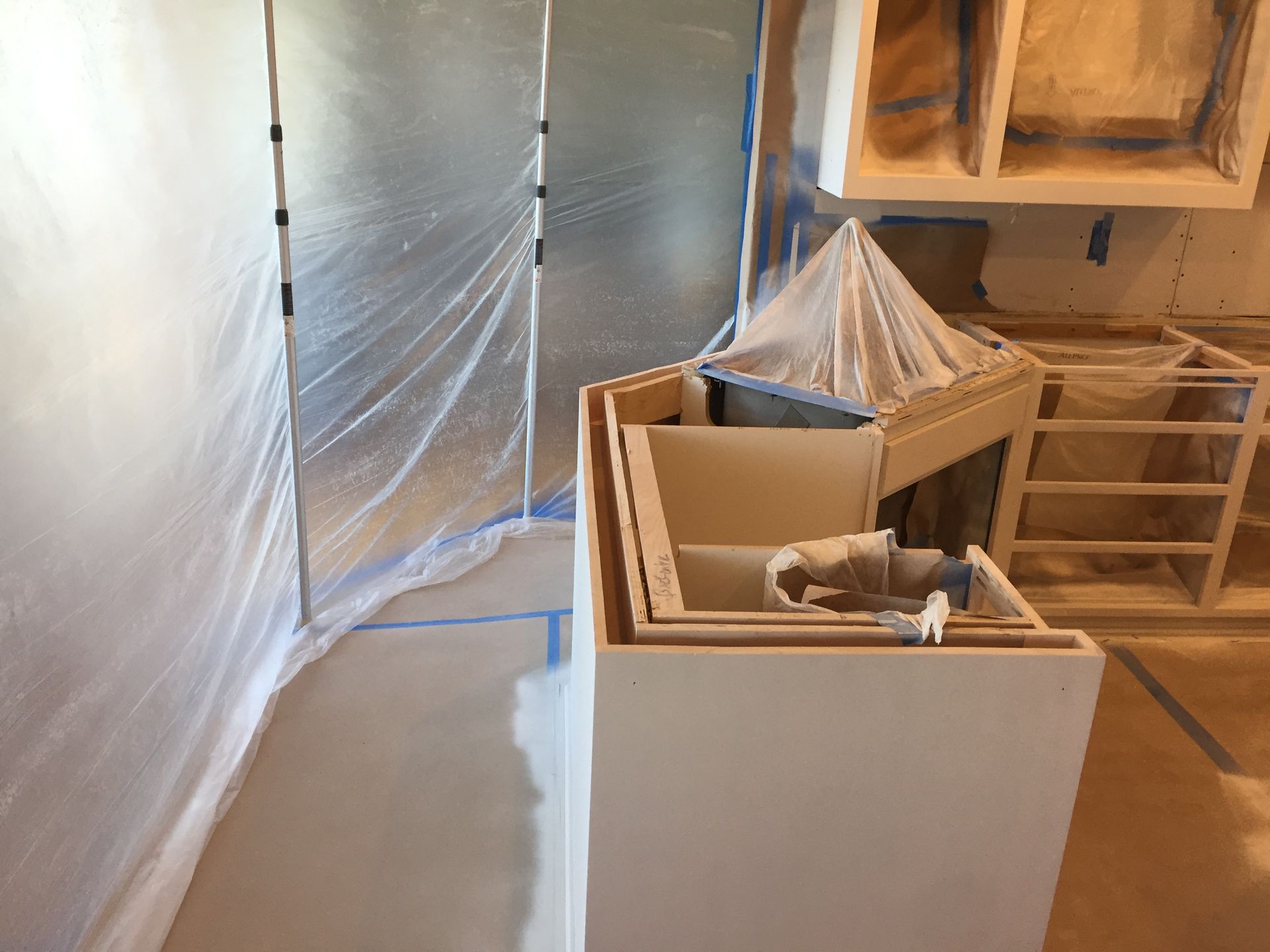 Room with a Lot of Cabinets Covered in Plastic — St Cloud, MN — Fine Line Paint LLC