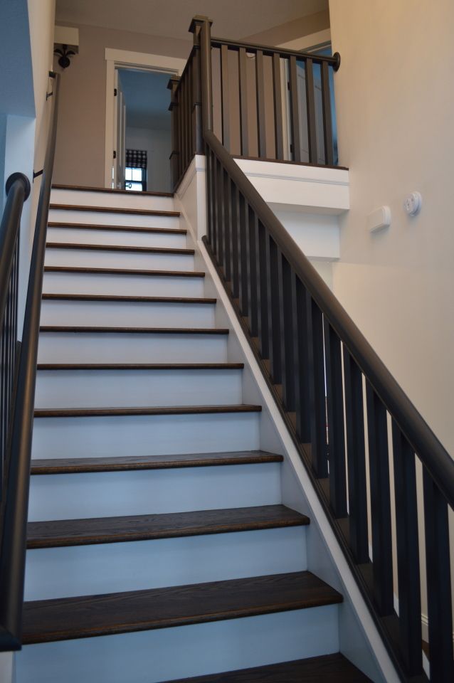 Staircase with White Steps and a Black Railing — St Cloud, MN — Fine Line Paint LLC
