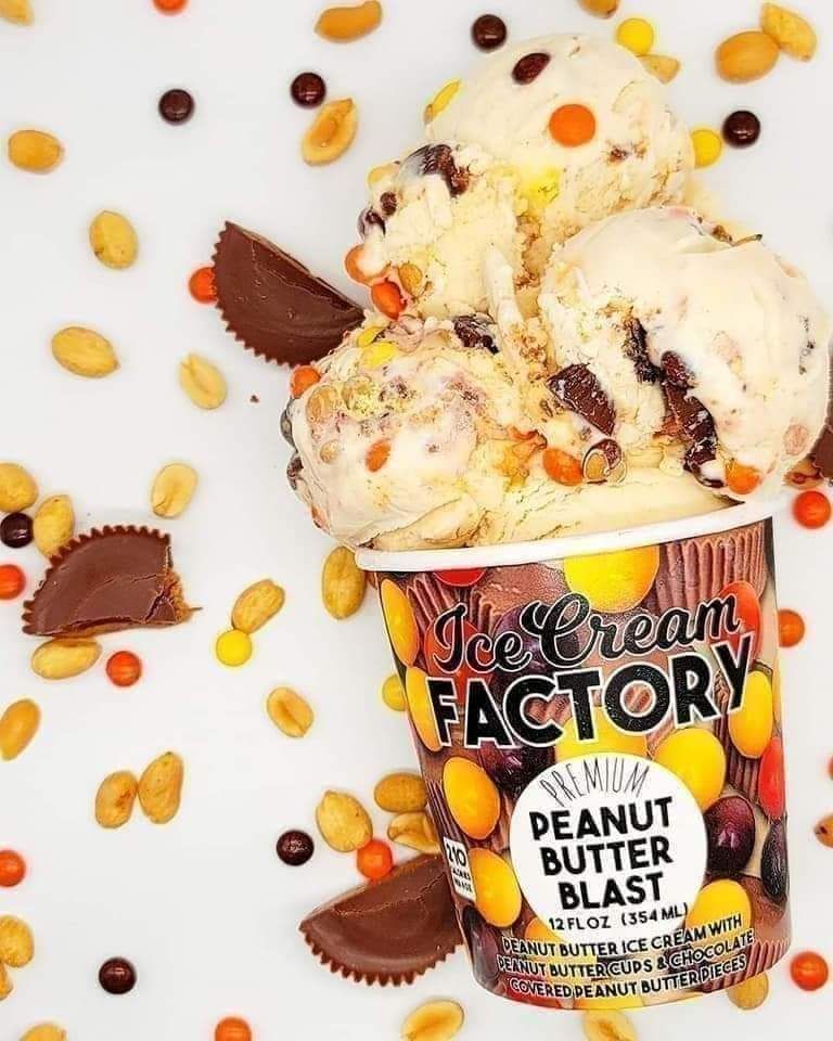 Ice cream pint labeled “Peanut Butter Blast” with peanut butter swirls and candy pieces on a white background