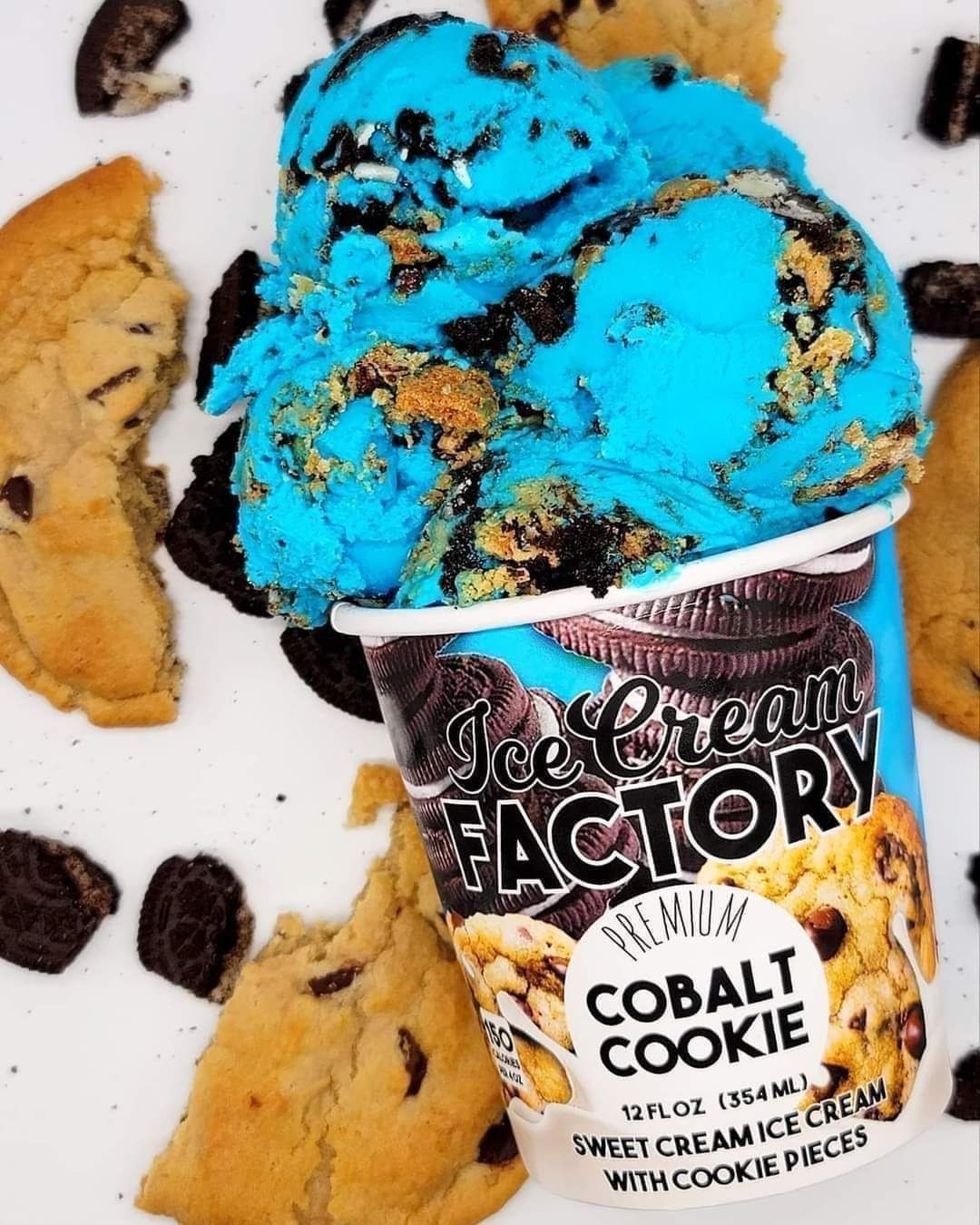 Bright blue cookie ice cream in a cup labeled “Ice Cream Factory Cobalt Cookie,” with cookie pieces around it