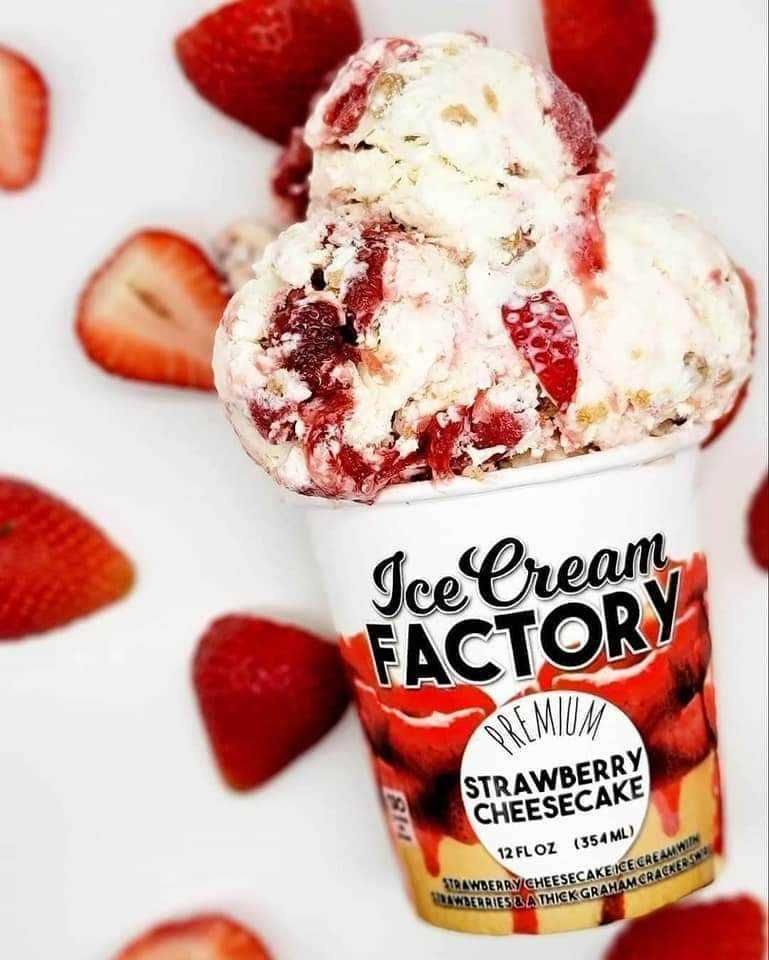 Ice cream pint labeled Strawberry Cheesecake with strawberry swirls and berries around it