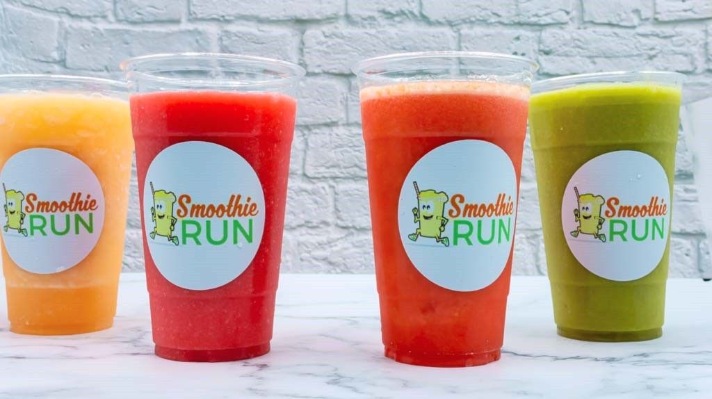 Four colorful smoothie cups with “Smoothie RUN” logos lined up on a light background