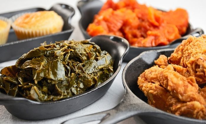 Assorted side dishes in black bowls, including fried chicken, greens, and red kimchi-like vegetables