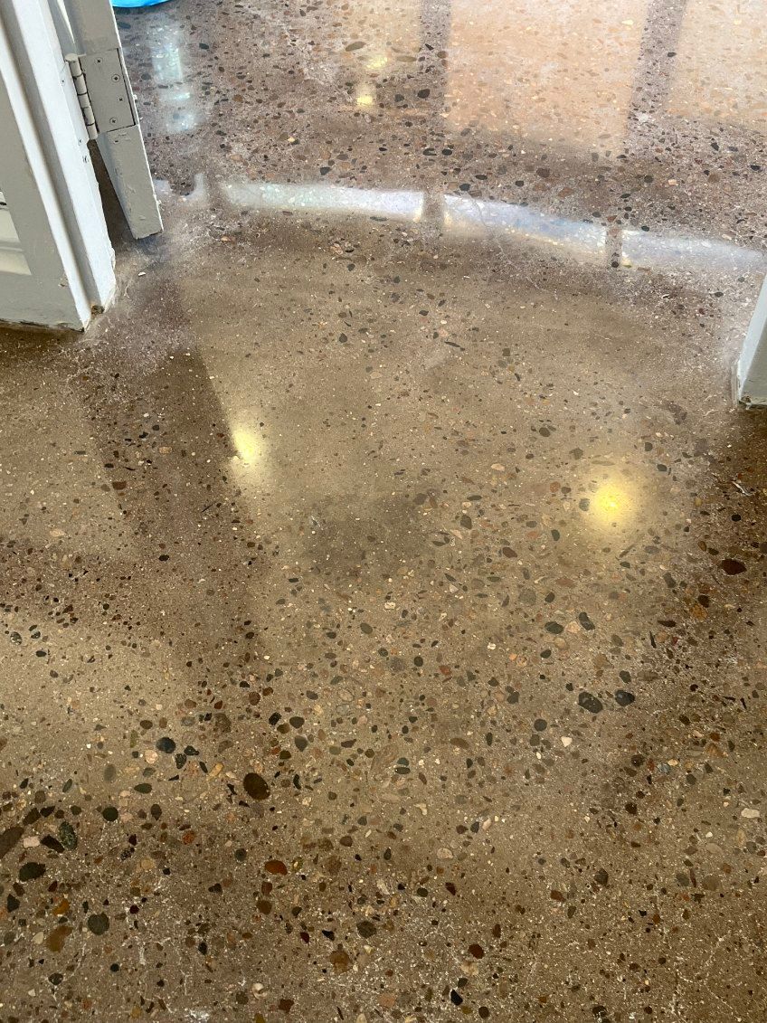 A close up of a shiny concrete floor in a room.