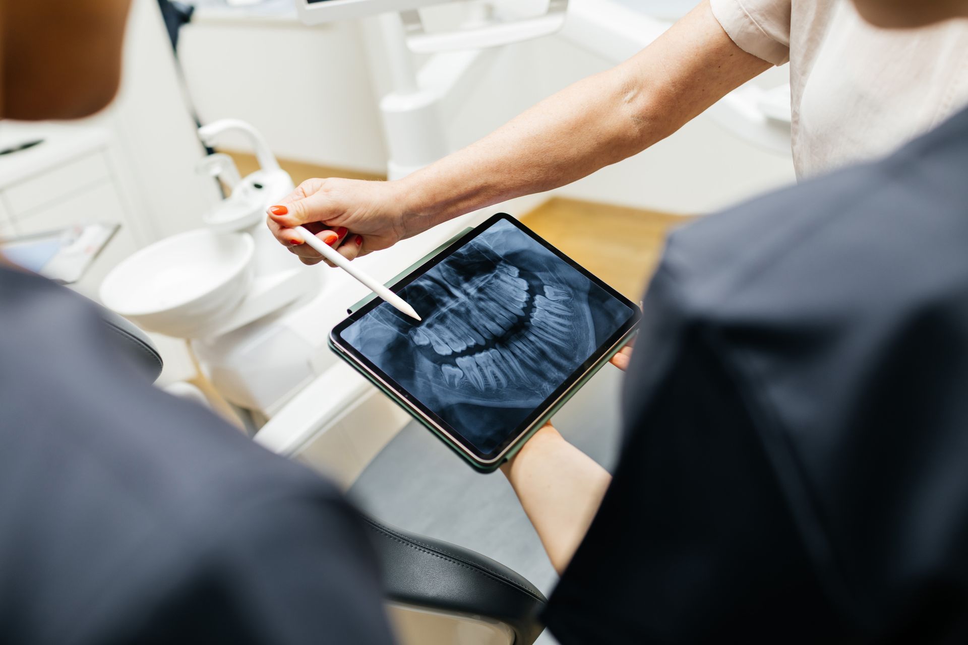 Dentist showing dental X-ray