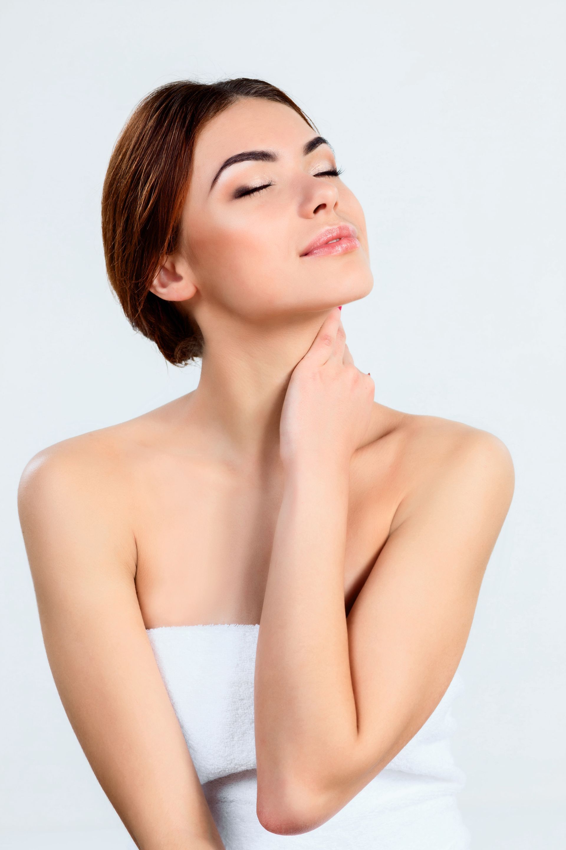 a woman with her eyes closed touches her neck with her hand