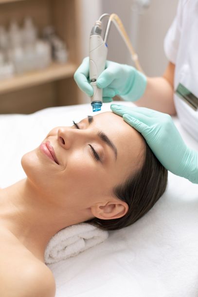 a woman is getting a treatment on her face