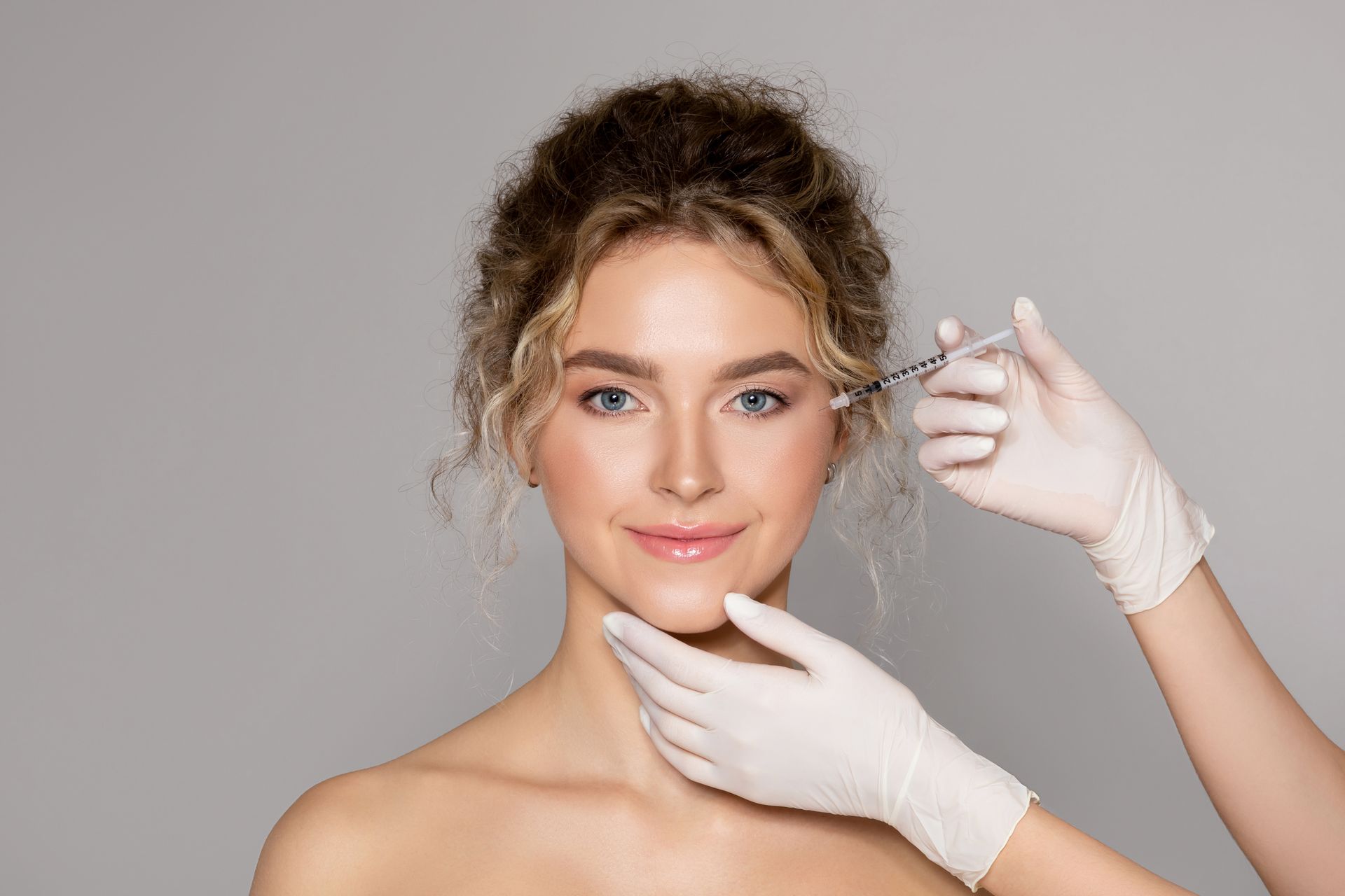 a woman is getting a botox injection in her face