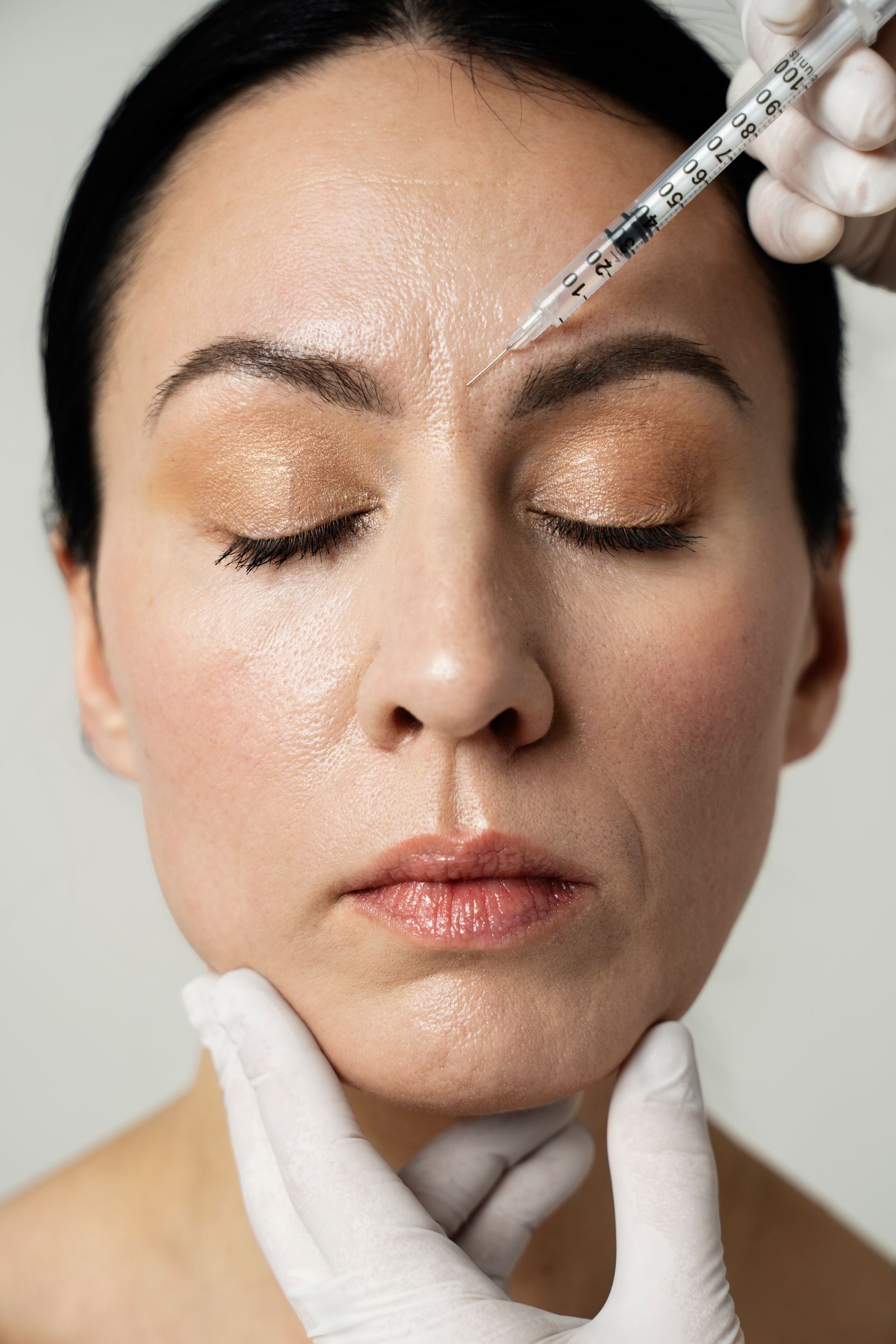 a woman is getting a botox injection in her face