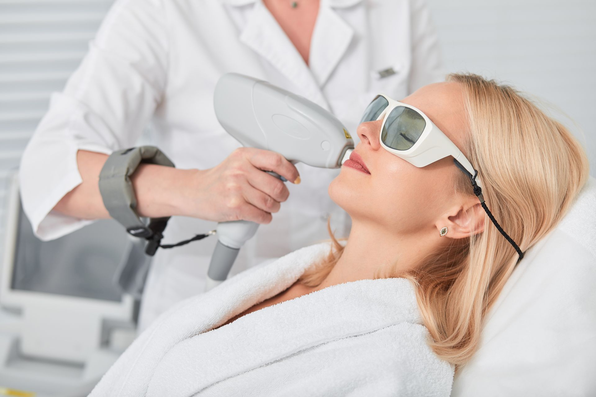 a woman is getting a laser treatment on her face