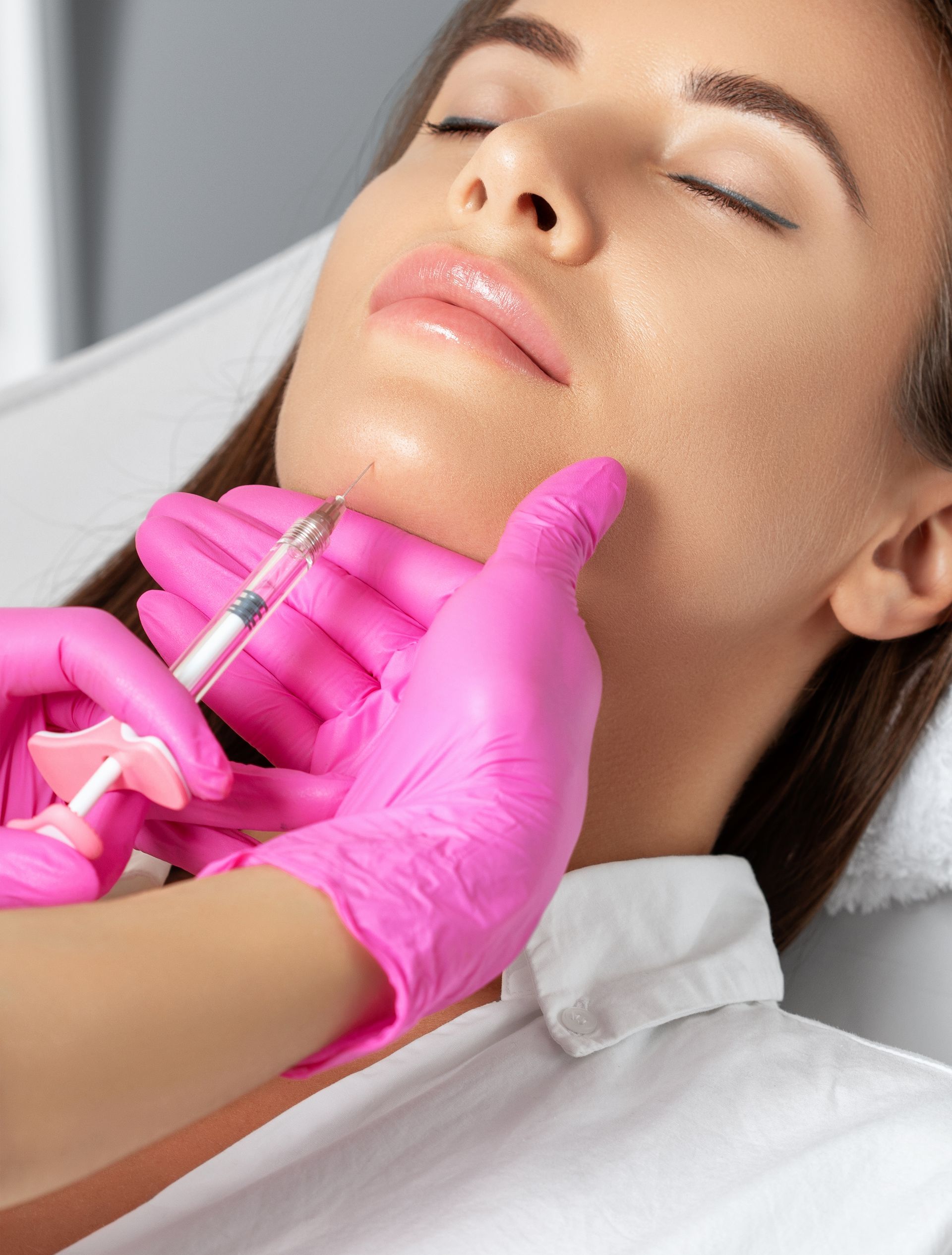 a woman is getting a botox injection in her face
