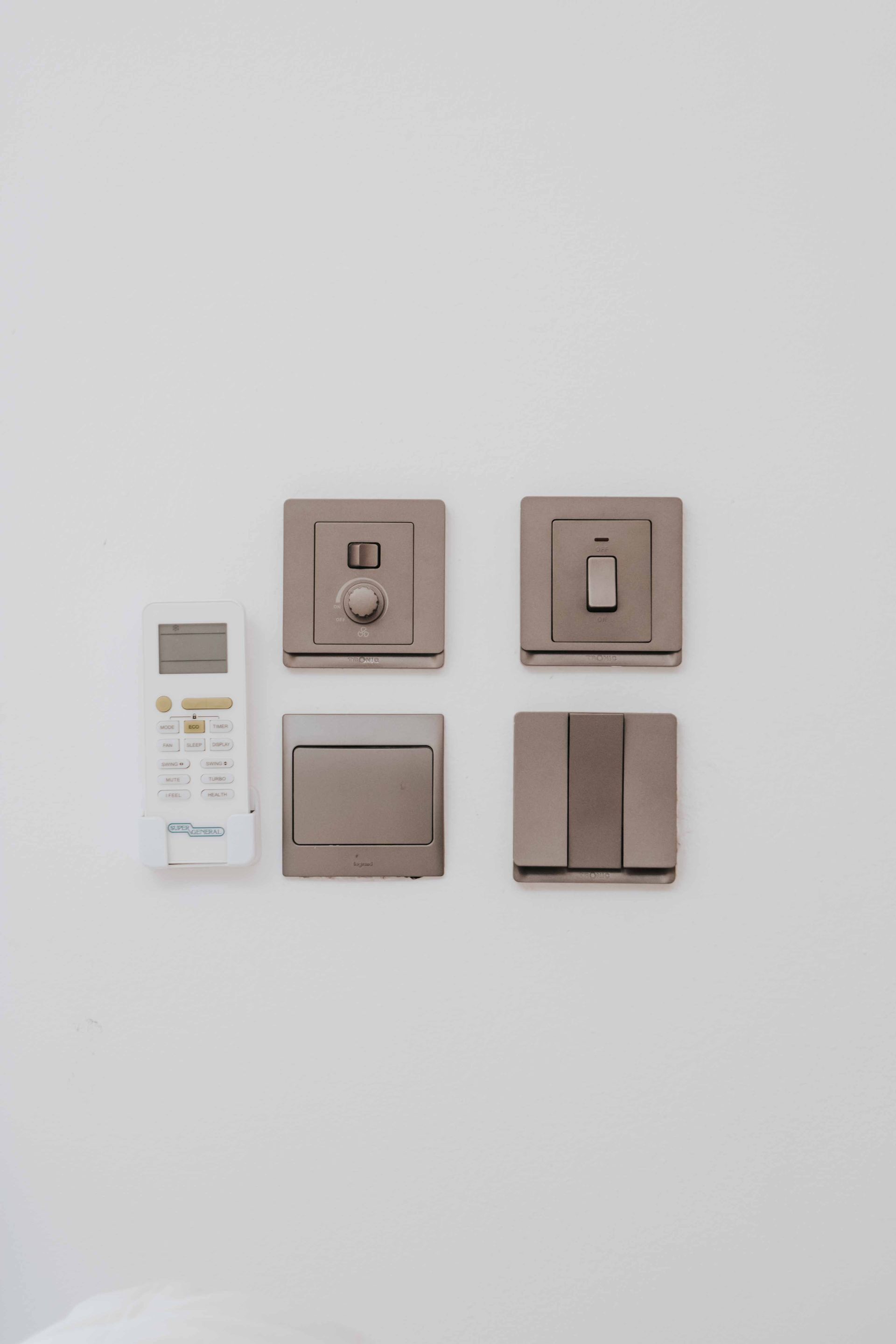 Cleanly installed three-prong residential grounded wall outlet and light switch.