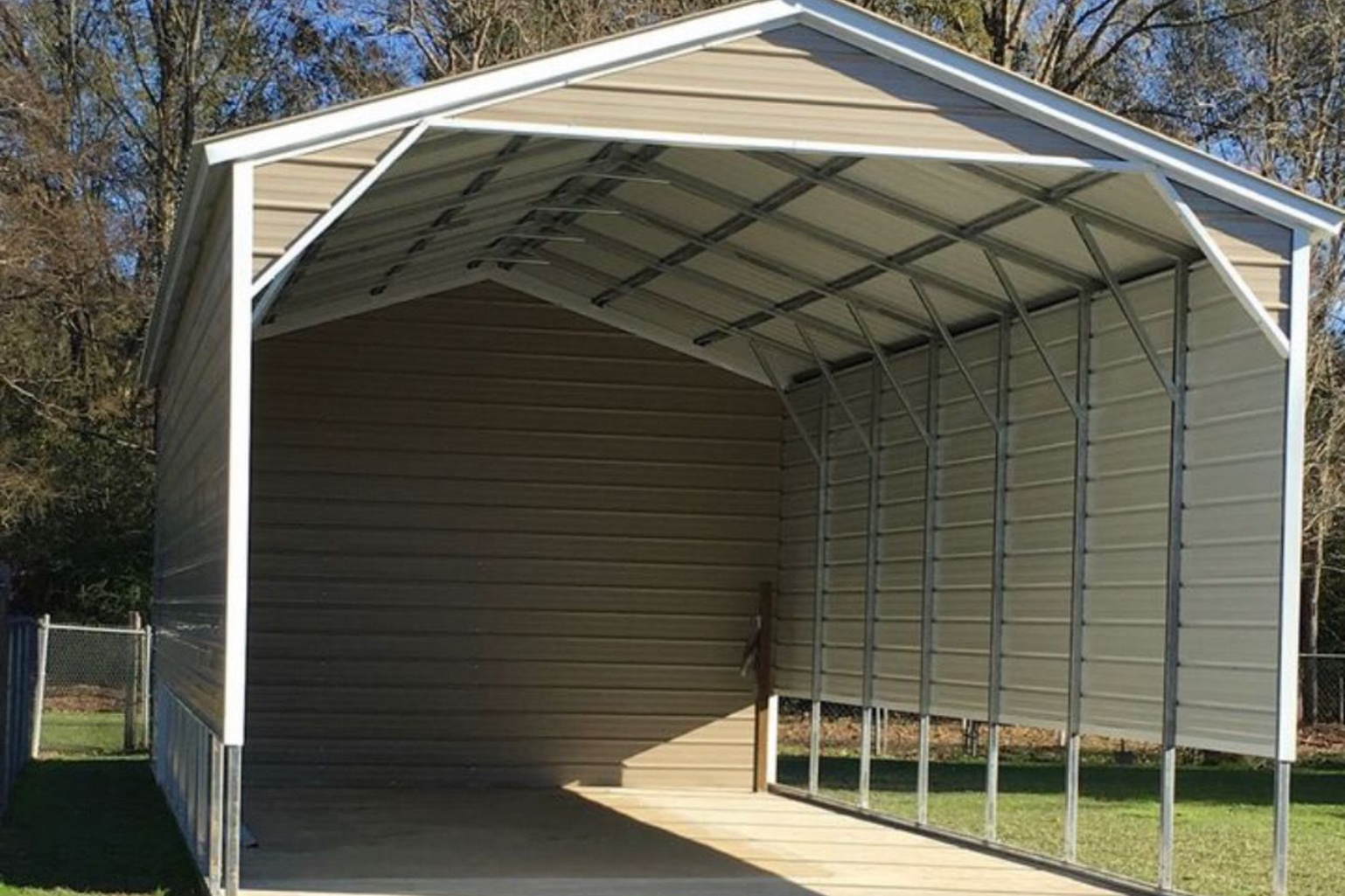 Metal carport with a white frame and tan roof over a paved driveway, open on the front and side.