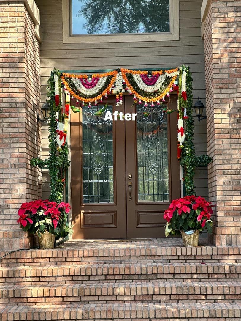 Brown double doors decorated with garlands and poinsettias, front porch.