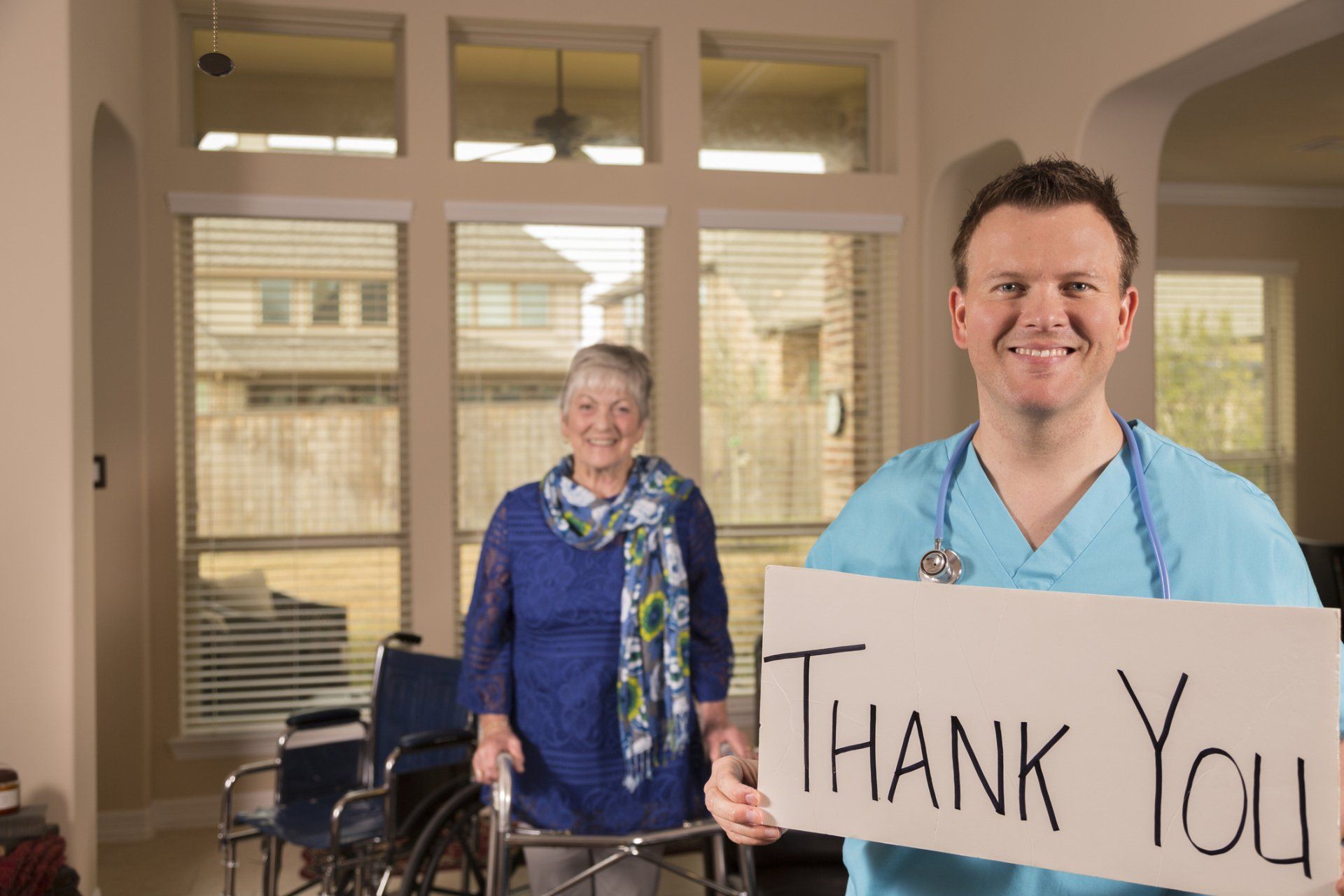 Smiling male caregiver holds a 