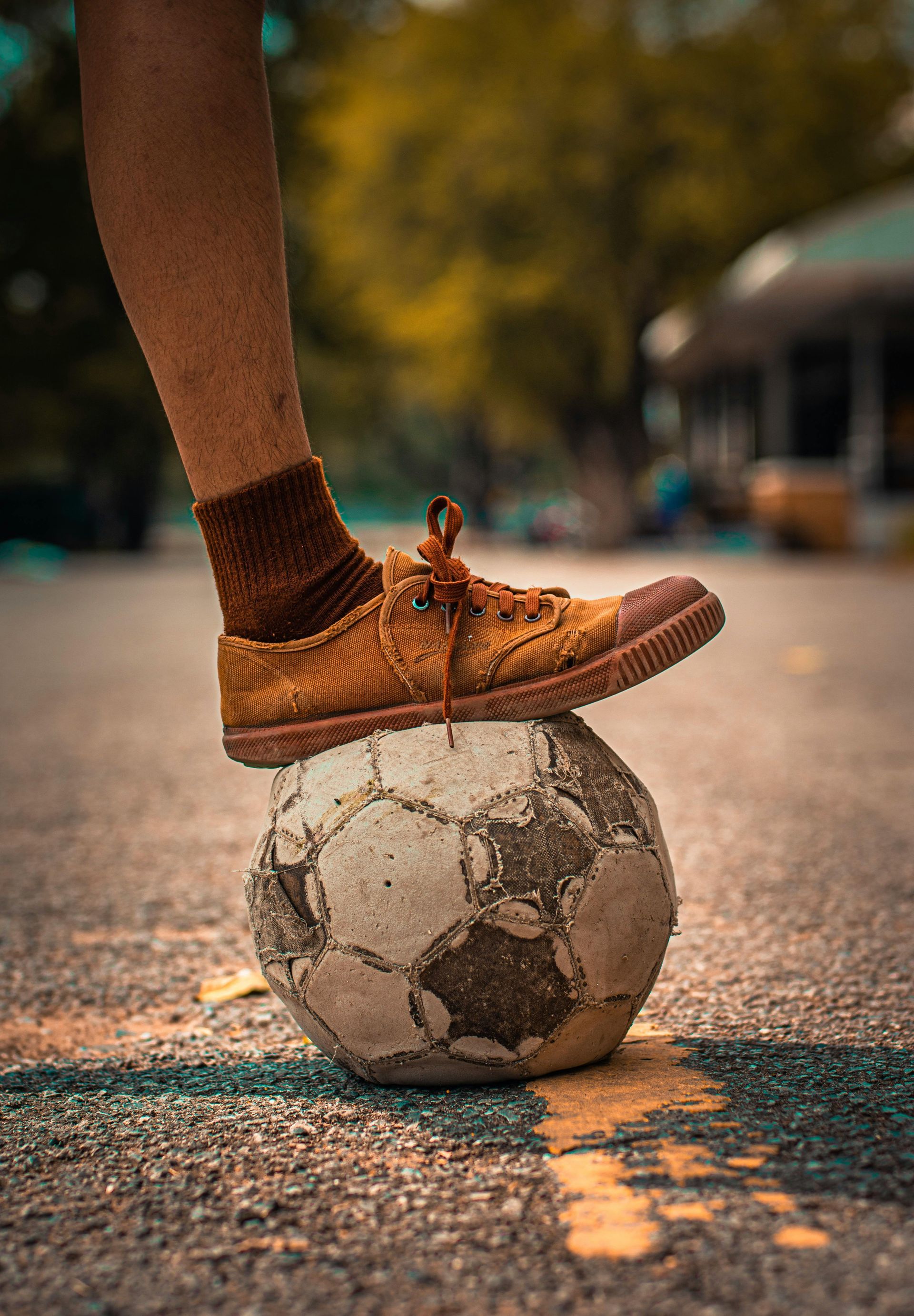 A person is balancing a soccer ball on their foot.