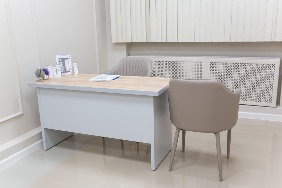 Consultation between a doctor and a patient across a desk