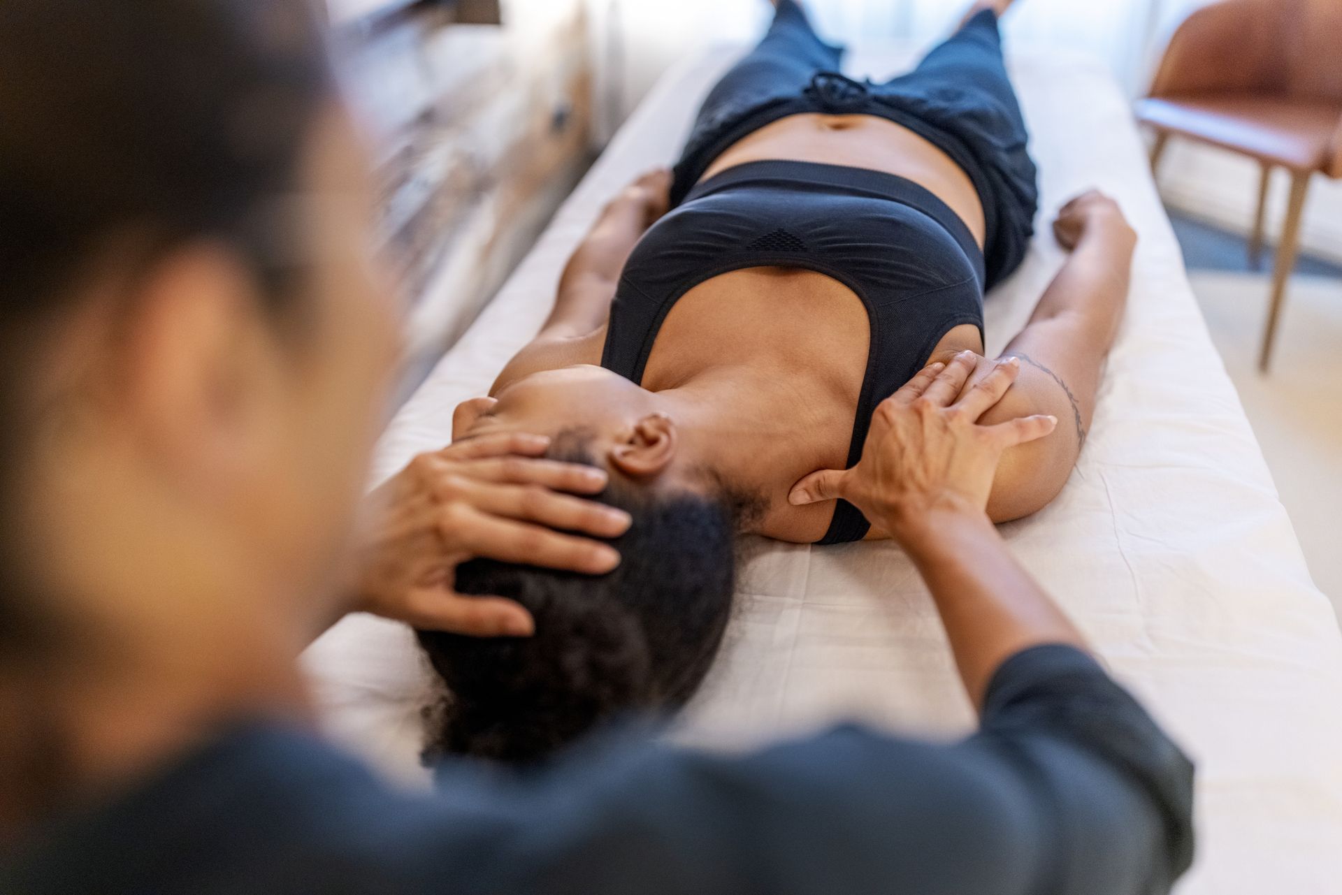 Patient suffering from neck and back problems during a chiropractic session.