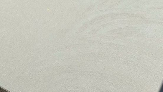 Close-up of a light grey textured shed slab