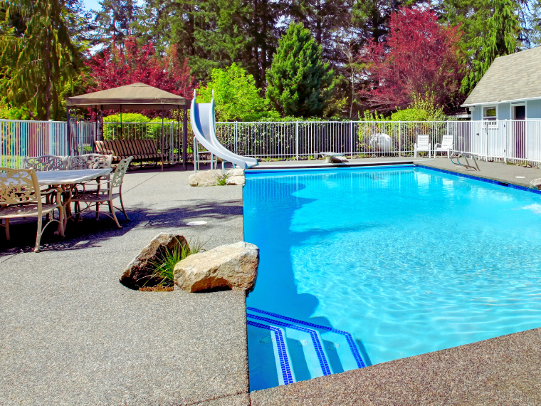 Exposed aggregate around pool in Backyard of property in Rockingham