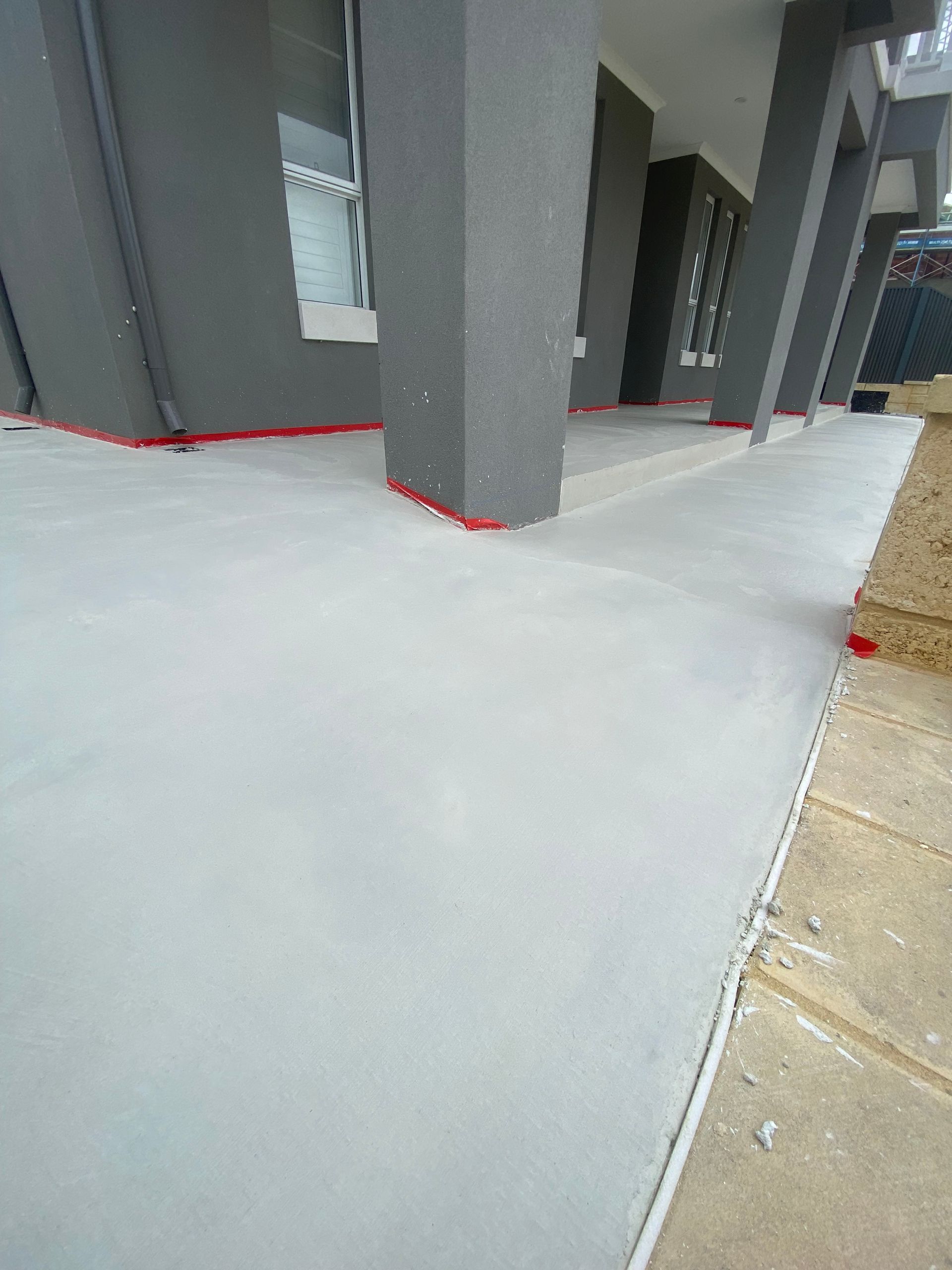 Standard grey concrete alfresco and ramp to front door of home