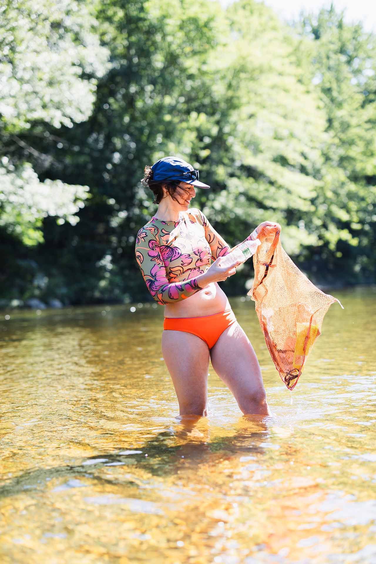 Woman Collecting Trash from River