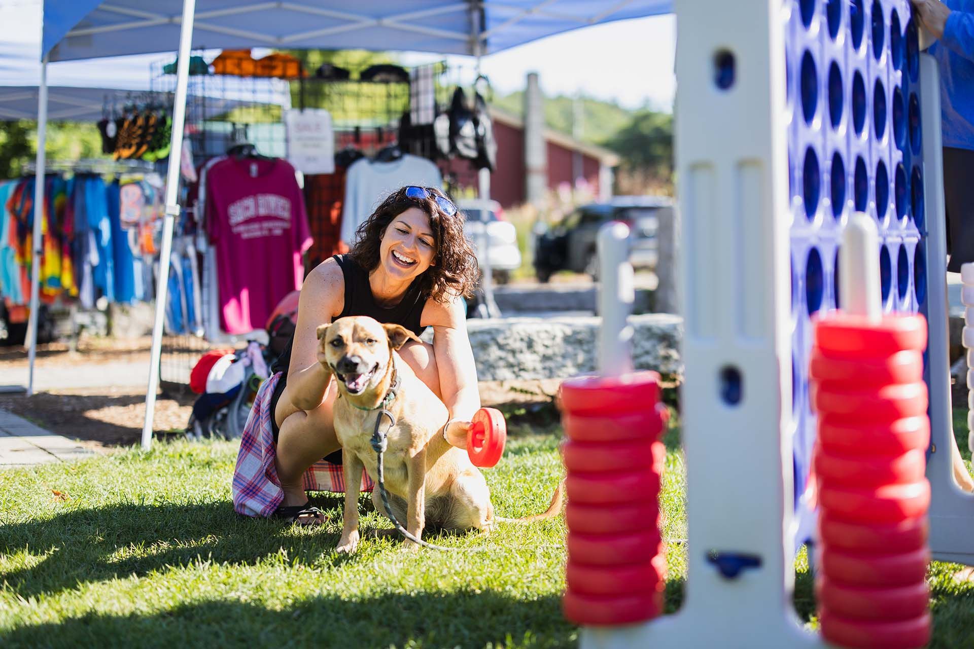 Woman Kneeling Down Next to A Dog
