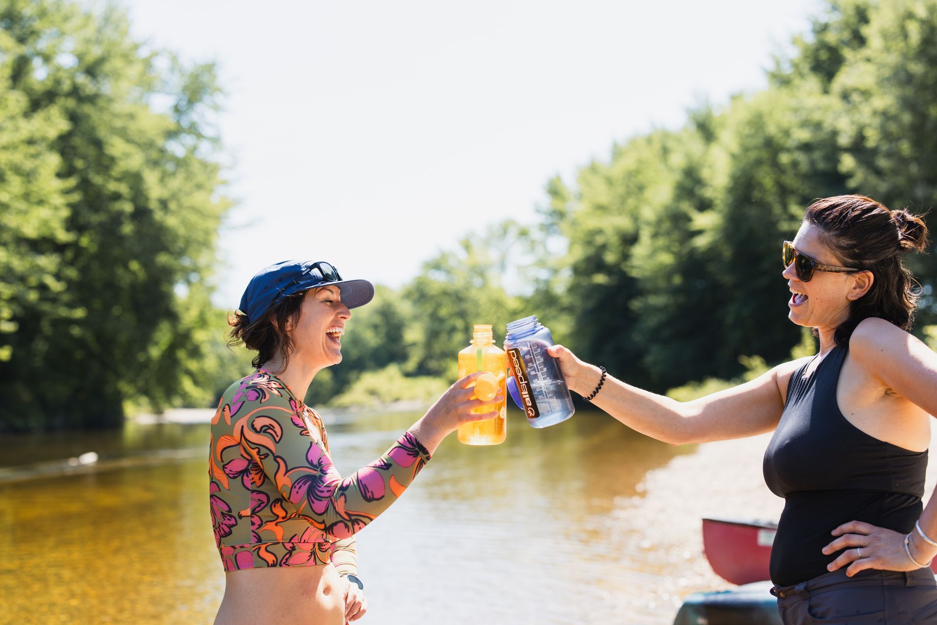 Two women on a river drinking water