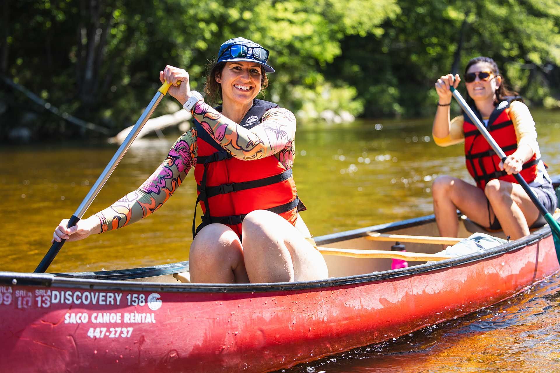 Two Women Are Rowing a Canoe