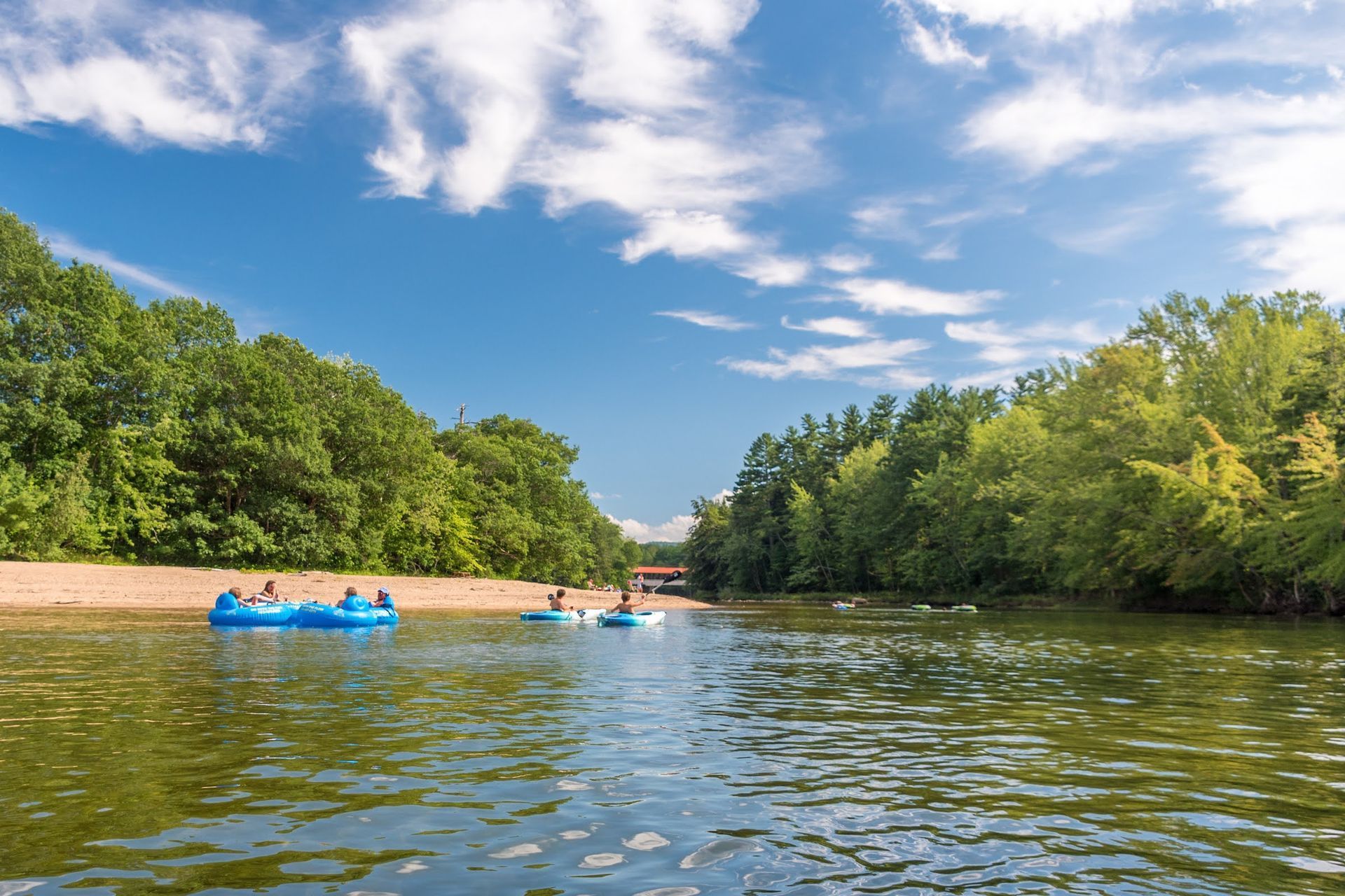 4 groups of people floating down a river 