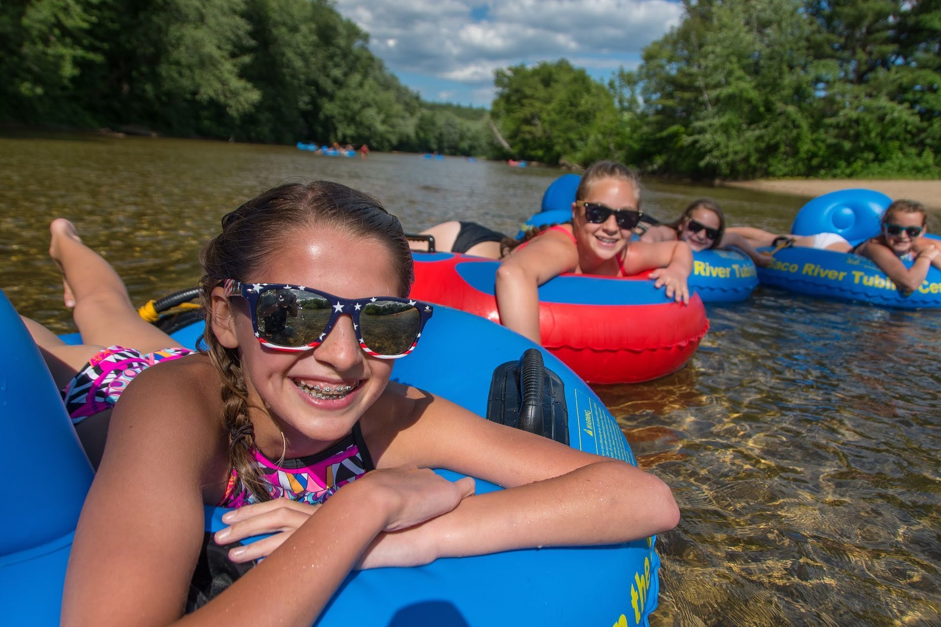 Family Floating Down a River on Inner Tubes