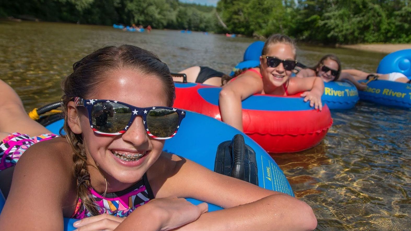 Family Floating Down a River on Inner Tubes