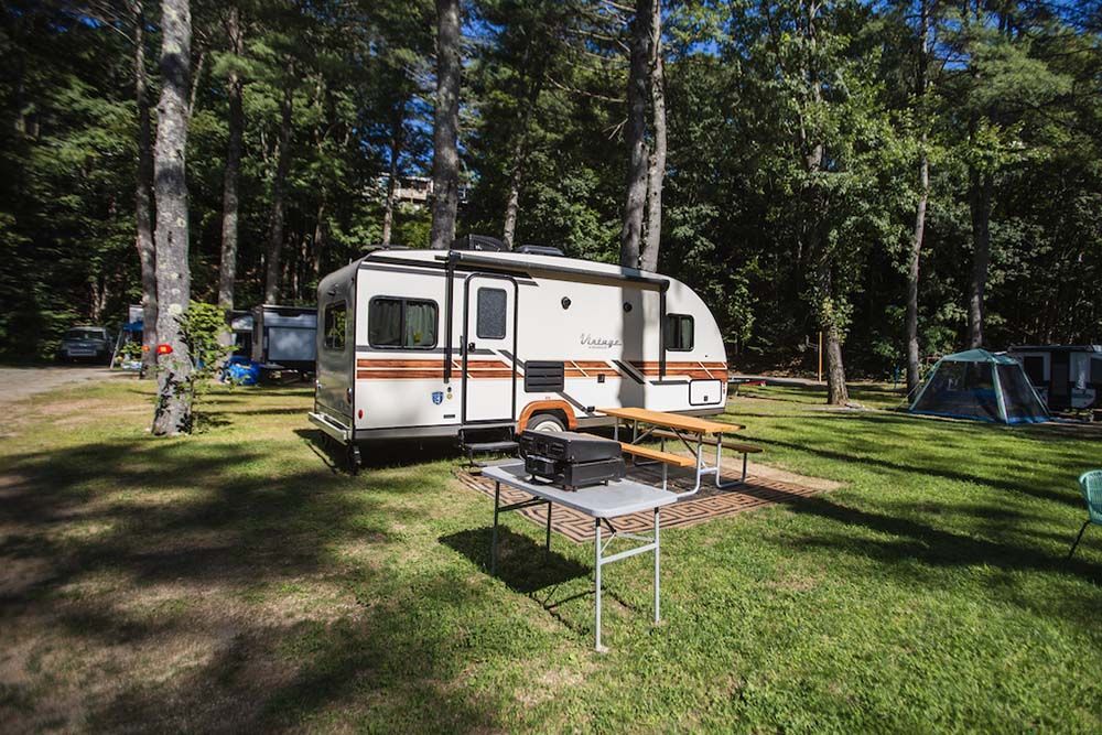 RV Parked in A Campground with A Picnic Table