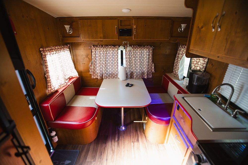 Inside of Rv with A Table and Benches