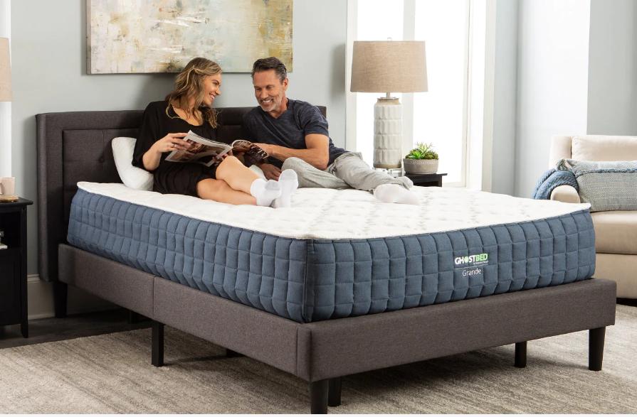 A blue and white mattress is sitting on top of a bed.