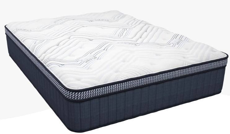 A mattress is sitting on top of a bed on a white background.