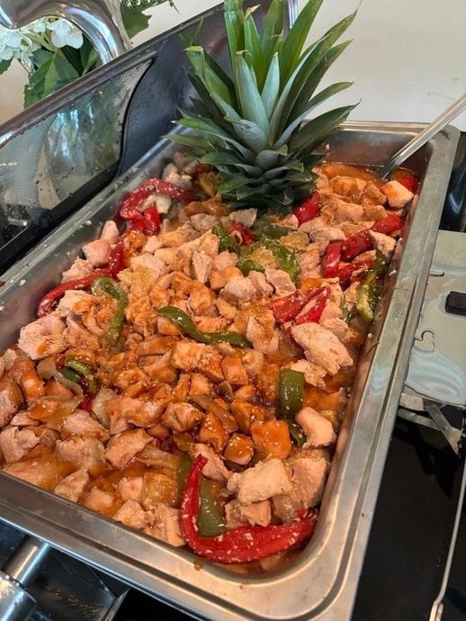 A tray of food with a pineapple on top of it.