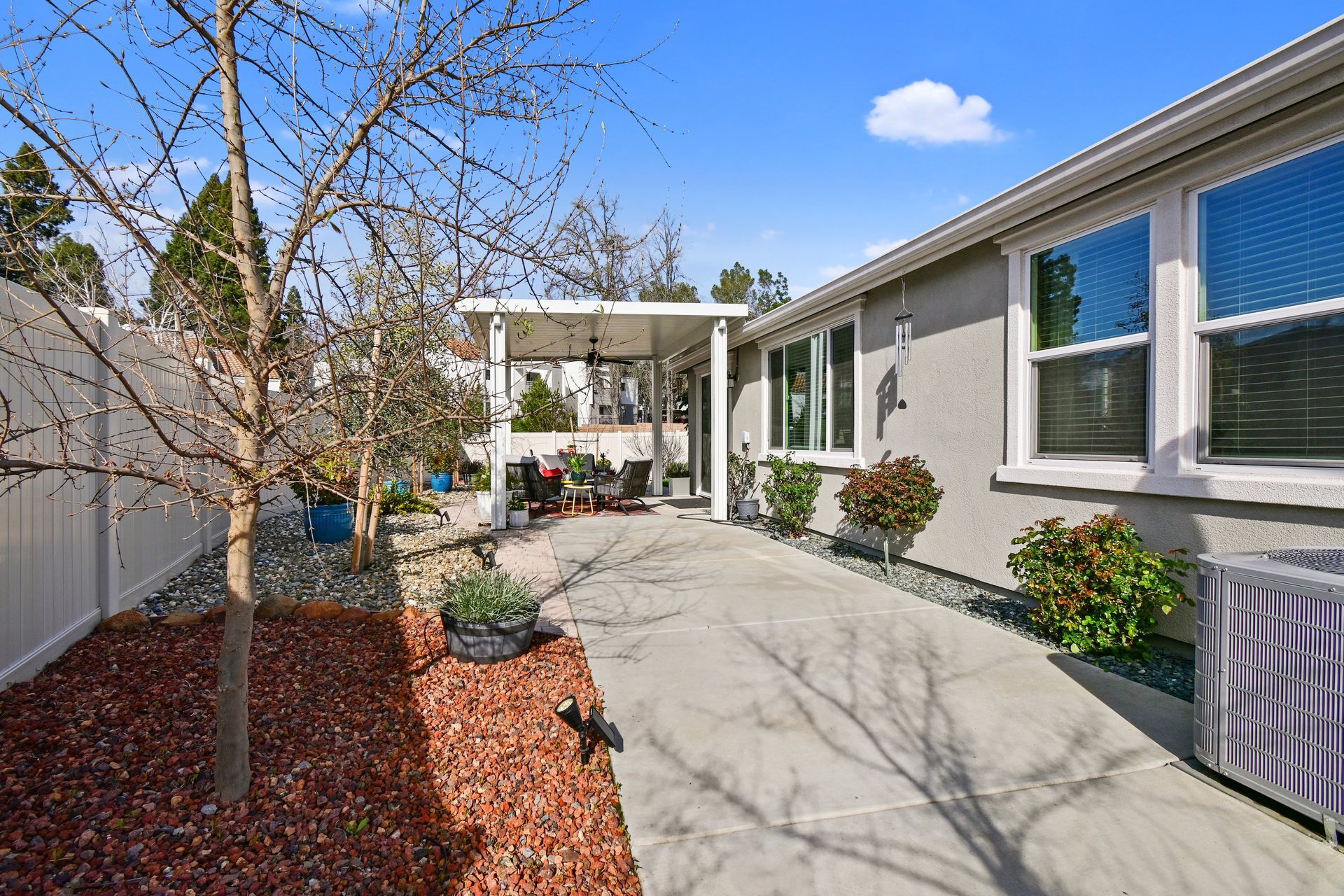 Walkway leading to backyard patio with landscaping, presented by an experienced Citrus Heights real estate agent.