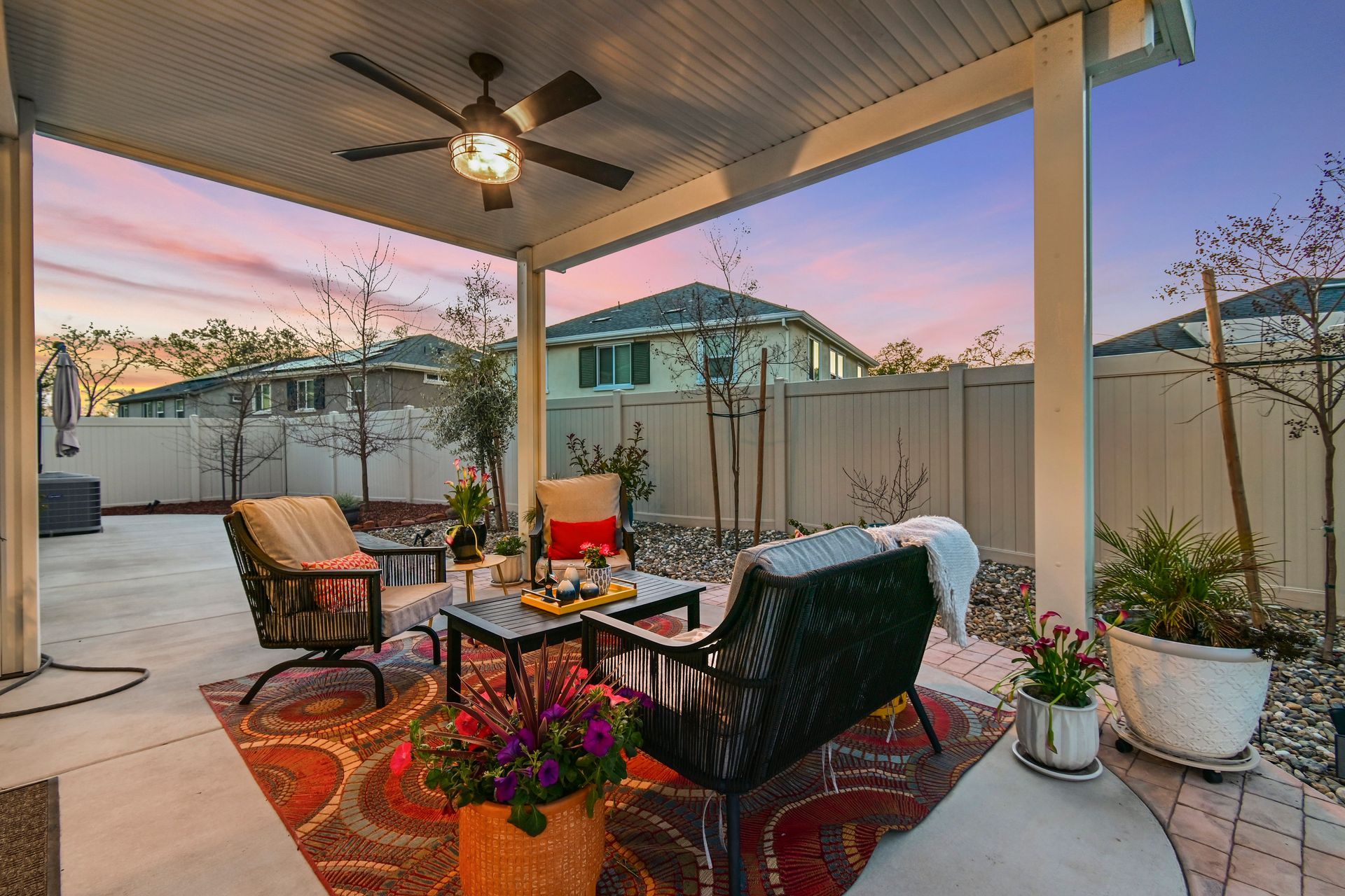 Twilight patio with cozy seating, ceiling fan, and potted plants, marketed by a listing agent in Citrus Heights.
