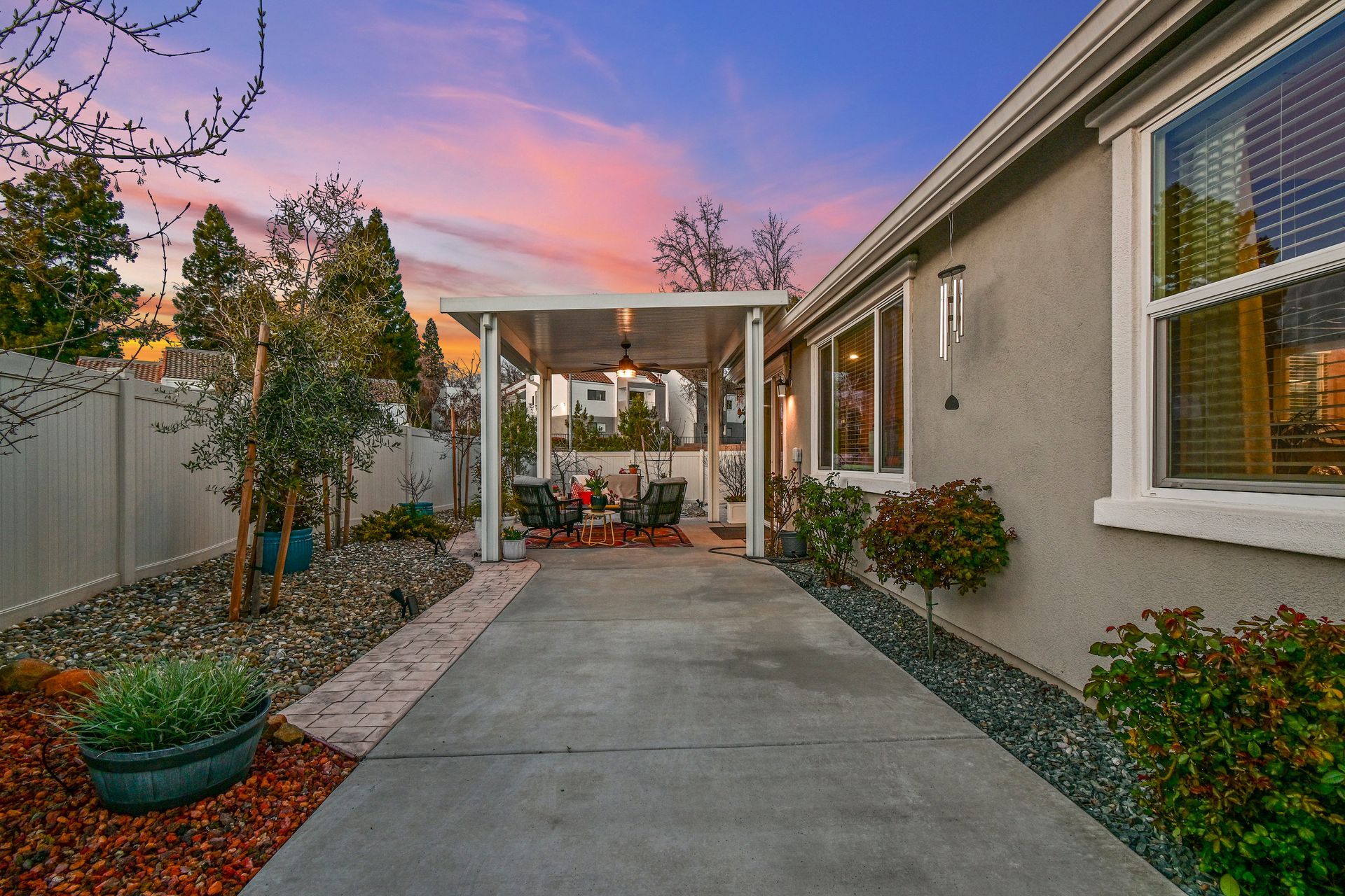Side yard view with landscaped path and patio at twilight, showcased by trusted listing agent in Citrus Heights.