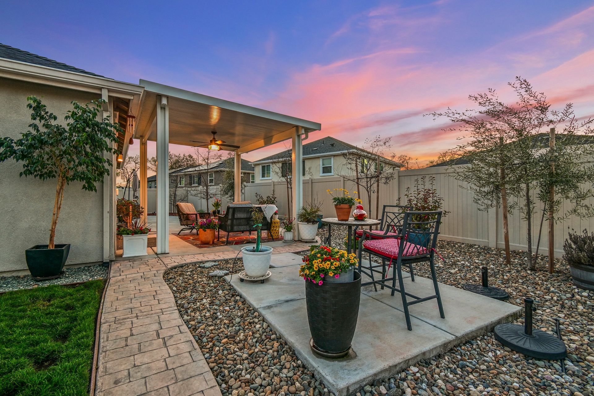Backyard with landscaped path and patio at sunset, showcased by an expert listing agent in Citrus Heights.