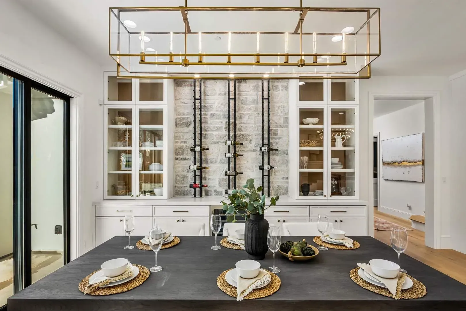 Elegant dining room with a built-in wine cellar and sophisticated decor in a luxury home.