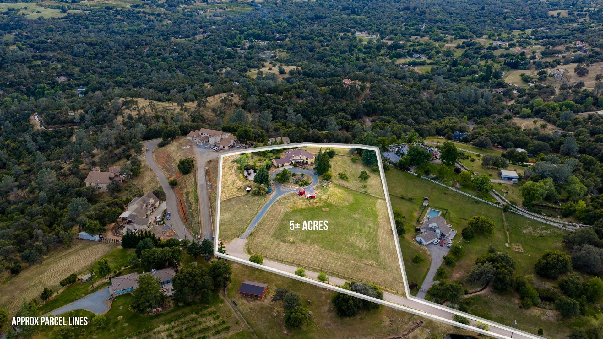 Aerial view of a 5-plus acre parcel with home and driveway surrounded by wooded landscape with property boundary lines marked.